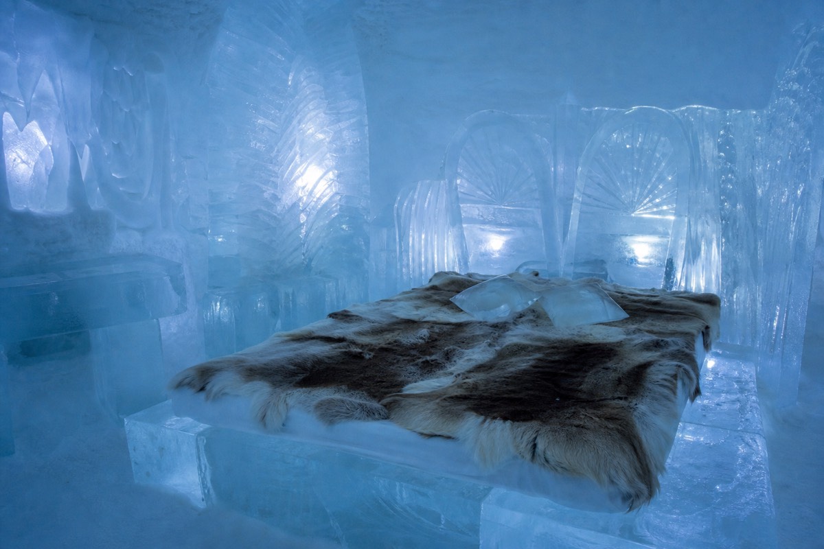 An ice room carved from snow and ice at a Lapland snow hotel