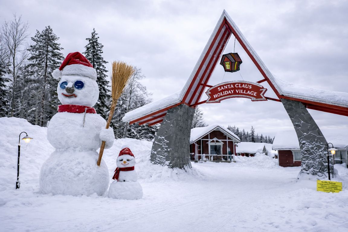 Santa Claus Village entrance in Rovaniemi Lapland with snowman and snowy surroundings, captured during a tour with Rovaniemi Tours